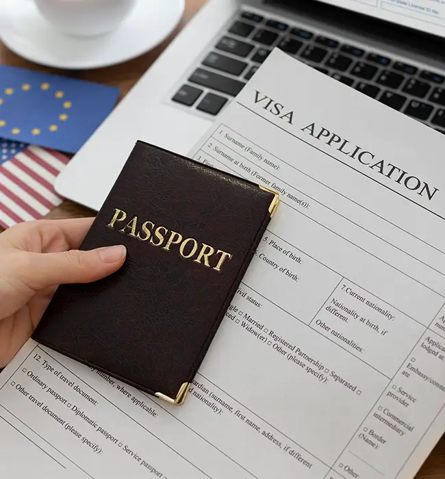 Various national flags with a visa application form, a passport, and a magnifying glass.