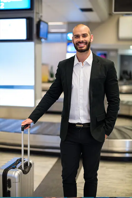 youngman in formals with trolley bag in the airport